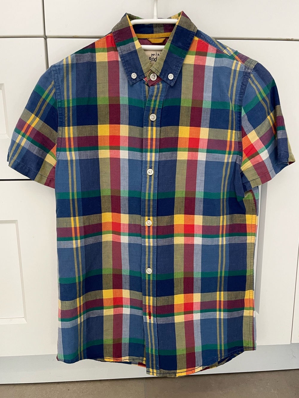 Mini Boden boy’s short-sleeve button-down in a vibrant multi-color plaid